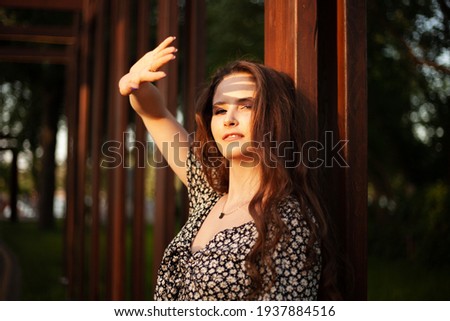 Similar – Portrait of a girl in red dress on a wooden door