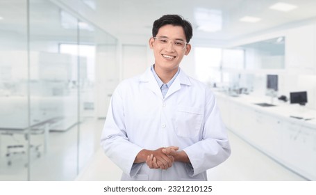 Portrait photo of a young handsome Asian male scientist in laboratory, friendly smile, white background. - Powered by Shutterstock