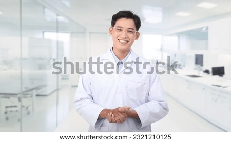 Portrait photo of a young handsome Asian male scientist in laboratory, friendly smile, white background.