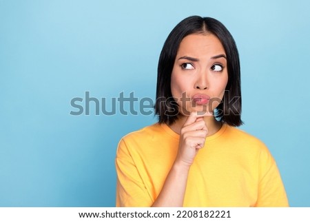 Portrait photo of young pretty adorable cute nice woman pouted lips look distrust empty space isolated on blue color background