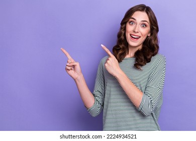 Portrait photo of young surprised woman curly hair fingers pointing empty space offer shopaholic crazy low price isolated on purple color background - Powered by Shutterstock