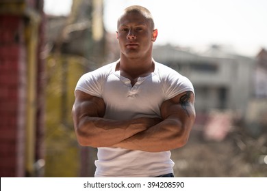 Portrait Of A Physically Fit Young Man Posing In Abondend Ruins - Shutterstock ID 394208590