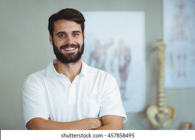 Portrait Of Physiotherapist Standing With Arms Crossed In Clinic