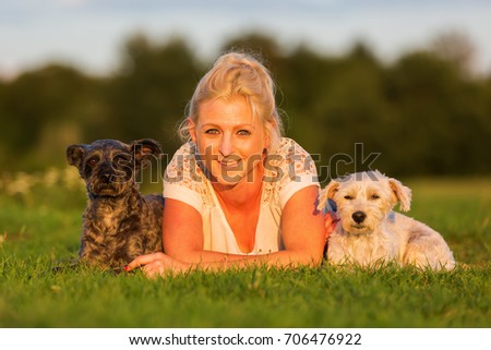 Similar – Image, Stock Photo Blond woman with her two dogs in the countryside