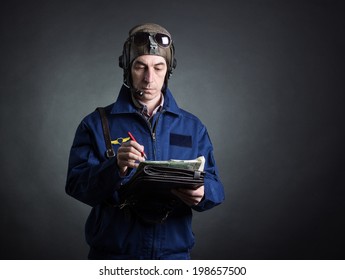 Portrait Of A Pilot With A Geographical Map In Hand.