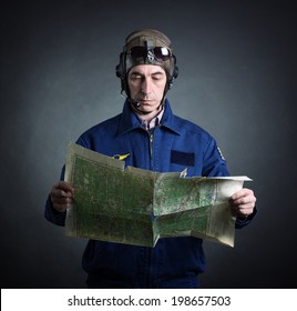 Portrait Of A Pilot With A Geographical Map In Hand.