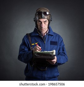 Portrait Of A Pilot With A Geographical Map In Hand.