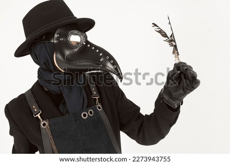 Portrait of a plague doctor from Medieval era holding a feather. high-quality costume. Isolated on a white background. epidemic and pandemic concept. Stockfoto © 