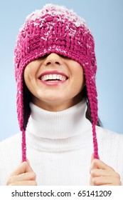 Portrait Of Playful Woman In Knitted Winter Cap Smiling