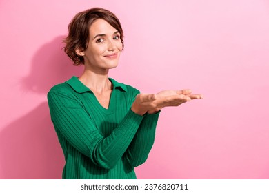Portrait of pleasant cheerful adorable woman wear stylish clothes plams demonstrate offer empty space isolated on pink color background