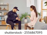 Portrait of police man officer talking to witnesses making interview sitting with young woman robbery victim after burglary interrogating her at home. Crime, robbery, safety of property concept.