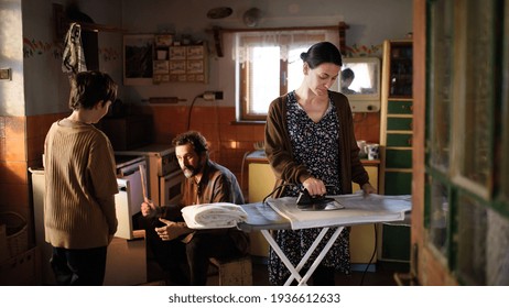 Portrait of poor mature couple with small daughter indoors at home, poverty concept. - Powered by Shutterstock