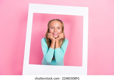 Portrait of positive adorable schoolchild hands touch cheeks toothy smile paper album card isolated on pink color background - Shutterstock ID 2248550891