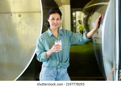 Portrait Of Positive Asian Woman Dairy Farm Worker Standing With Glass Of Fresh Milk