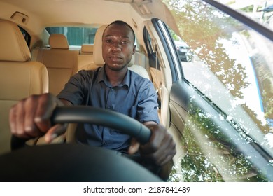 Portrait Of Positive Black Man Driving Car Through City