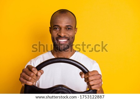 Portrait of positive cheerful afro american guy hold steering wheel enjoy traveling road route adventure wear good look clothes isolated over bright color background