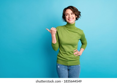 Portrait of positive cheerful girl promoter indicate point thumb copyspace, ads promotion recommend suggest select wear stylish pullover isolated blue color background - Powered by Shutterstock - Get 15% off with code: PIKWIZARD15
