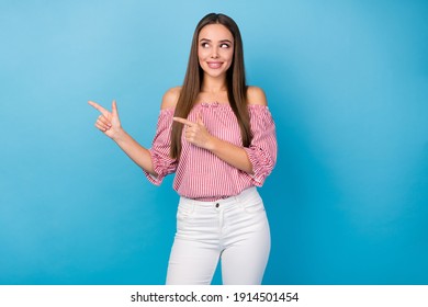 Portrait of positive cheerful girl promoter point index finger copyspace wear trousers blouse isolated blue color background - Shutterstock ID 1914501454