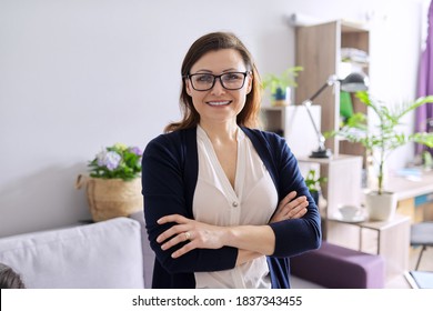 Portrait Of Positive Confident Mature Woman With Folded Arms, Female Doctor, Psychiatrist, Psychologist, Therapist Working In Office, Smiling Looking At Camera