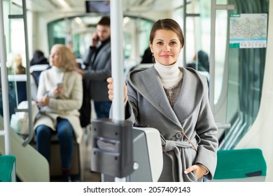 Portrait of positive female passenger traveling in tram. High quality photo