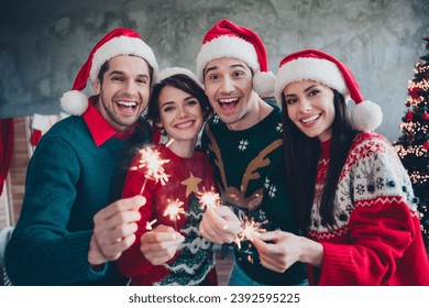 Portrait of positive friendly people have good mood hold new year bengal fires sticks loft interior indoors - Powered by Shutterstock