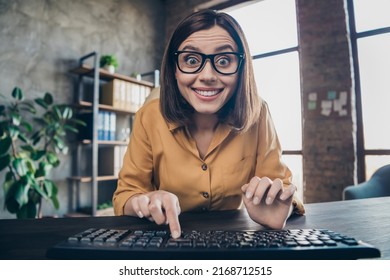 Portrait of positive funny lady finger press keyboard look camera office building indoors