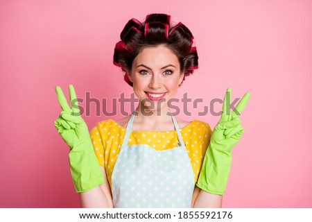 Portrait of positive girl make v-sign rubber gloves wear yellow dotted t-shirt isolated on pastel color background