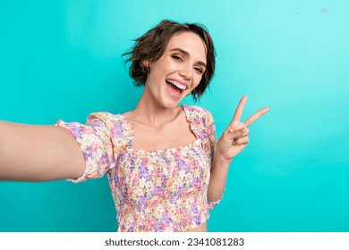 Portrait of positive gorgeous person beaming smile take selfie arm fingers demonstrate v-sign isolated on turquoise color background - Powered by Shutterstock