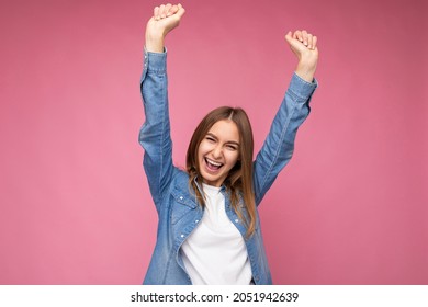 Portrait Of Positive Happy Amazing Young Beautiful Dark Blonde Woman With Sincere Emotions Wearing Blue Denim Shirt And White T-shirt For Mockup Isolated Over Pink Background With Copy Space And