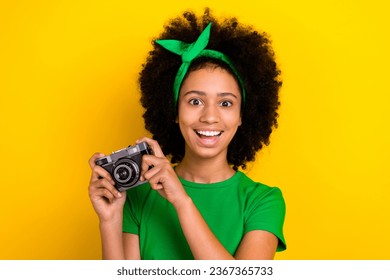 Portrait of positive lovely person toothy smile have good mood hands hold photo camera isolated on yellow color background - Shutterstock ID 2367365733