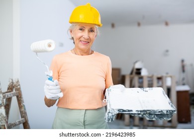 Portrait Of Positive Mature Woman Posing With Painting Wall Tools, Renovating Home With Her Own Hands