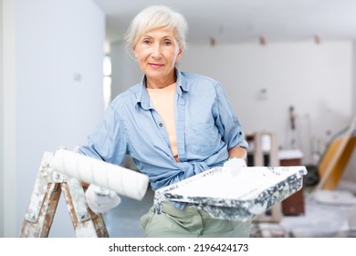 Portrait Of Positive Mature Woman Posing With Painting Wall Tools, Renovating Home With Her Own Hands