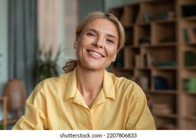 Portrait Of Positive Middle Aged Female Psychologist Talking To Camera And Smiling During Therapy Session In Office. Friendly Psychotherapist Posing In Cabinet