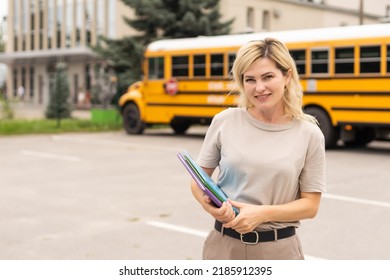 Portrait Of Positive Middle Aged Woman Teacher, Psychologist, Mentor, Therapist, Counselor Near The School Bus