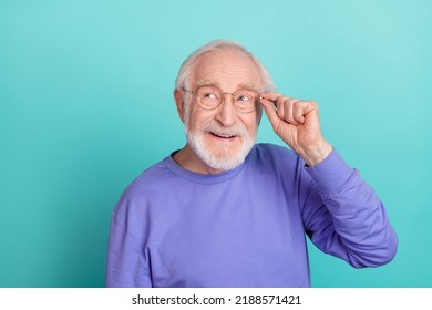 Portrait of positive minded person hand touch glasses look interested empty space isolated on teal color background - Powered by Shutterstock