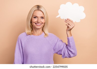 Portrait of positive nice person toothy smile arm hold empty space cloud shape card isolated on beige color background - Shutterstock ID 2254799035