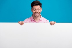 Portrait Of Positive Person Toothy Smile Look Interested Down Empty Space Blank Isolated On Blue Color Background