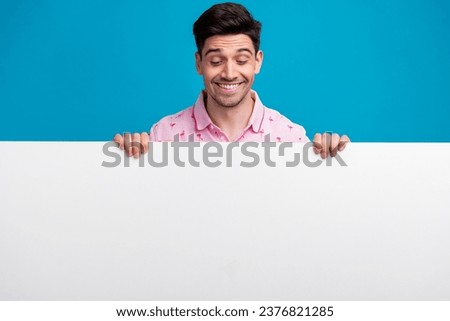 Portrait of positive person toothy smile look interested down empty space blank isolated on blue color background