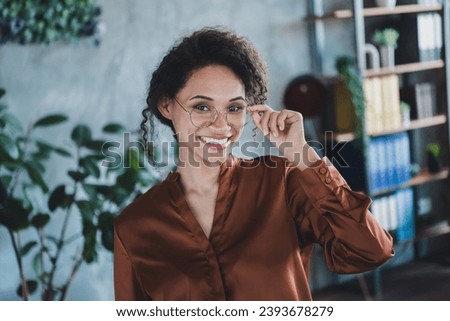 Portrait of positive pretty company founder lady toothy smile arm touch glasses modern office building inside