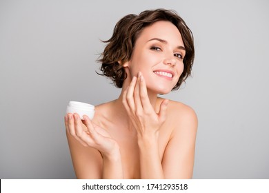 Portrait Of Positive Pretty Girl Prepare Dating Look In Mirror Apply New Skin Care Cream On Her Face To Make Face Soft Fresh Nature Isolated Over Grey Color Background