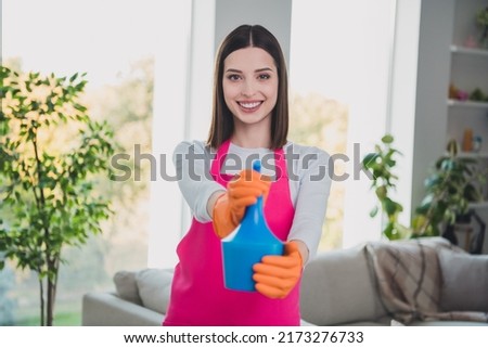 Portrait of positive pretty person hands hold cleaning spray bottle beaming smile look camera house indoors
