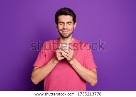 Portrait of positive satisfied guy visit barista hold mug smell cappuccino beverage enjoy aroma close eyes wear good look outfit isolated over shine color background