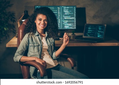 Portrait Of Positive Skilled Afro American Girl Web Designer Engineer Sit Chair Enjoy Her Night Company Data Work Hold Glasses In Workplace Workstation