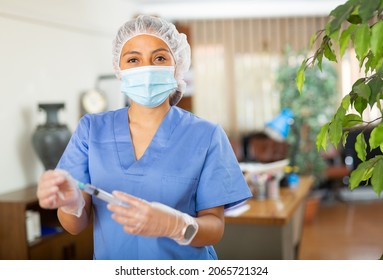 Portrait Of Positive Woman Healthcare Worker Holding Syringe For Injection Or Vaccination