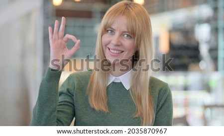 Portrait of Positive Woman showing OK Sign 