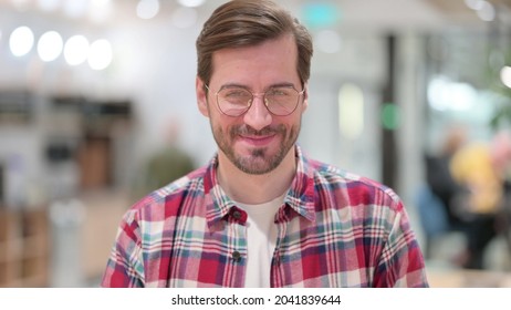 Portrait Of Positive Young Man Saying Yes By Shaking Head