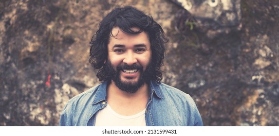 Portrait of powerful man with full beard outdoor in urban style