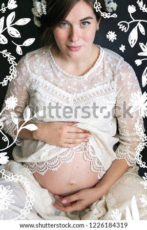 portrait of a pregnant girl in a white lace dress with flowers in her hair