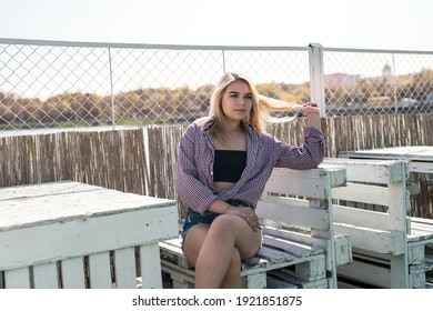 portrait of pret woman sitting on wooden chair, enjoy summer hot sunny day - Shutterstock ID 1921851875