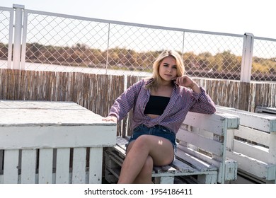 portrait of pret woman sitting on wooden chair, enjoy summer hot sunny day - Shutterstock ID 1954186411